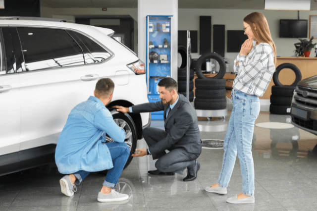 man testing wheels on new car
